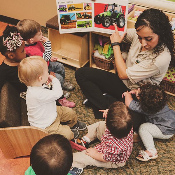 Woman identifying pictures with young children