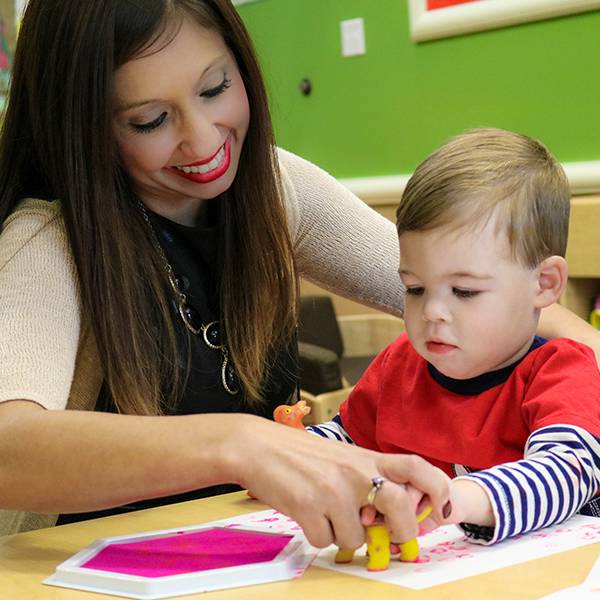 Woman painting with young child